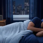 Man sleeping in a modern bedroom with a bedside sound machine for white noise or brown noise