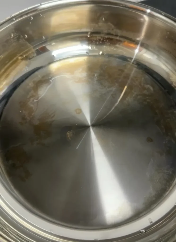 Stainless steel cookware with residue before cleaning