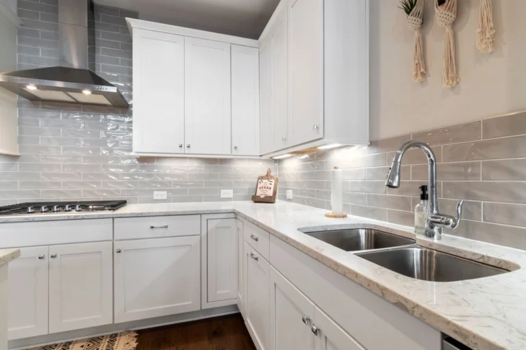 Bright kitchen with a stainless steel sink and white cabinetry