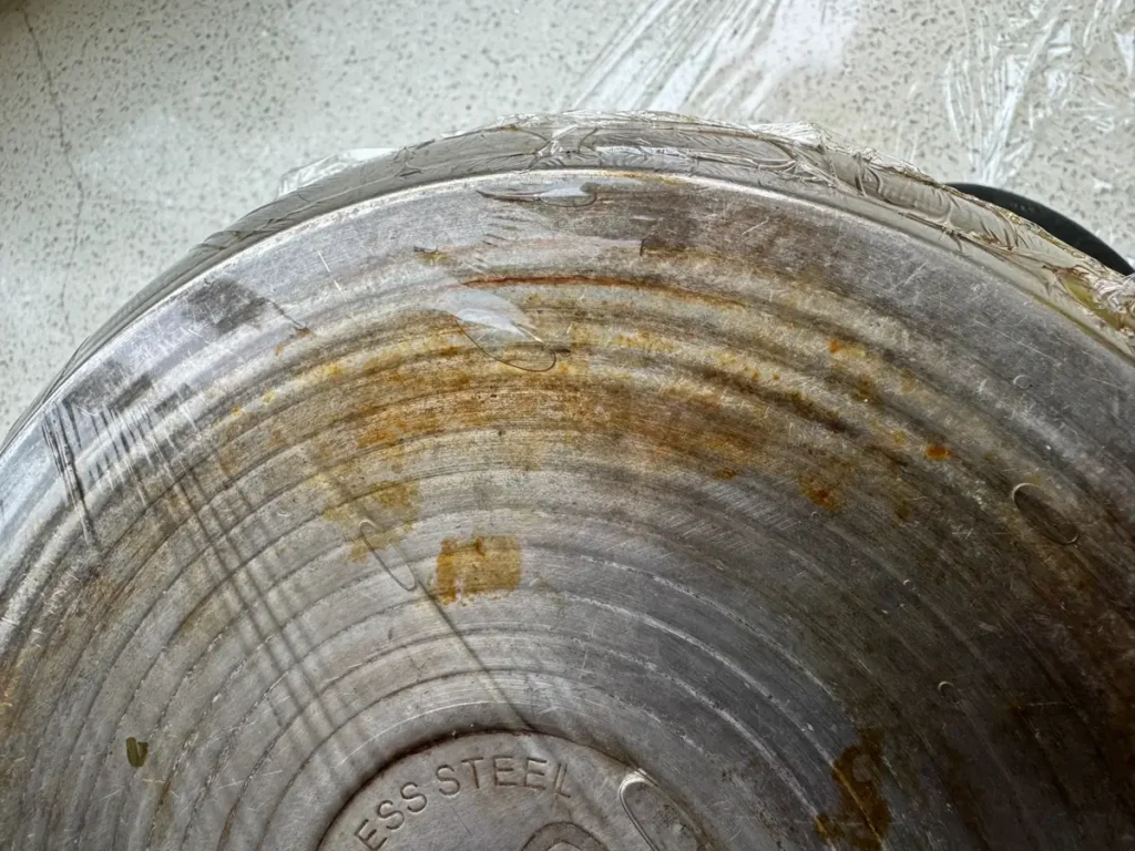 Stained stainless steel pot bottom before cleaning