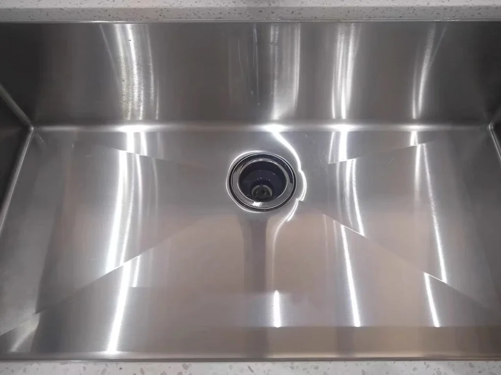 Stainless steel sink after cleaning with a cleaner and more even finish