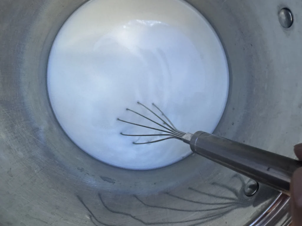 Milk heating in a stainless steel pot for homemade yogurt