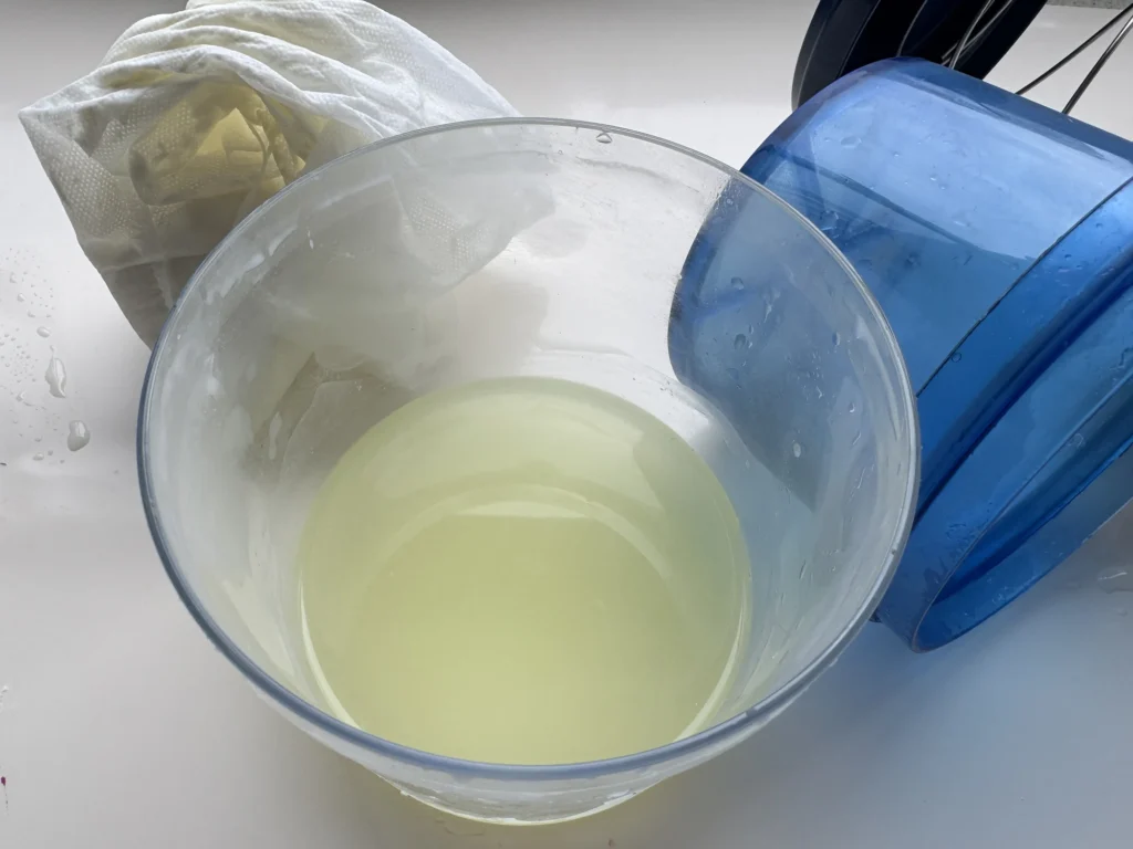 Pale yellow whey collected after straining homemade yogurt