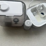 Disassembled humidifier with water tank, base, and filter ready for cleaning