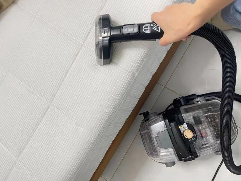 Using a cleaning machine on the surface of a mattress