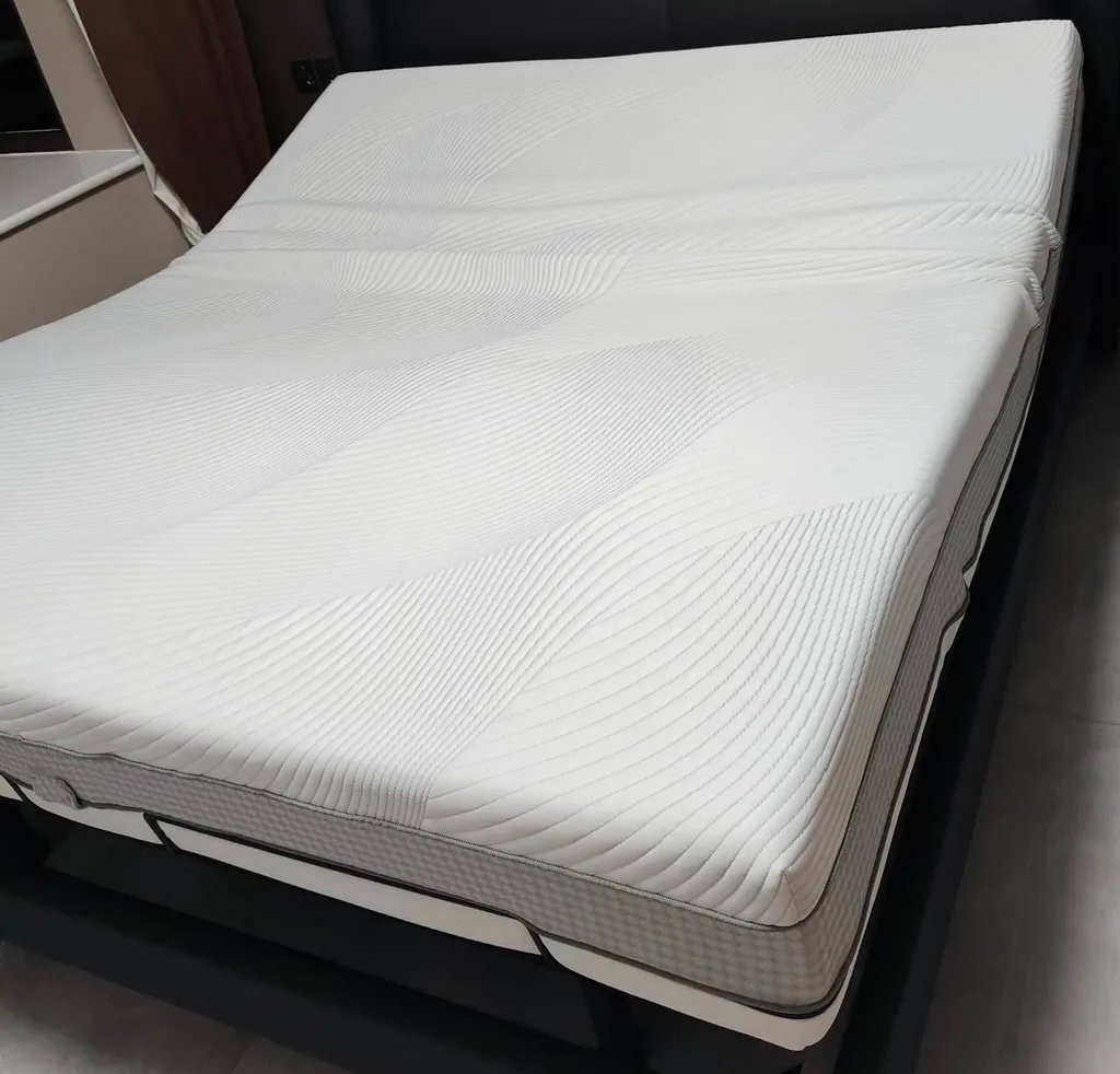 Memory foam mattress displayed on a bed in a bedroom