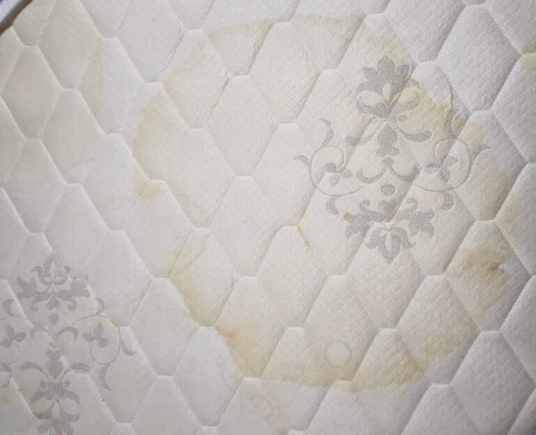 Light yellow stains on a white quilted mattress